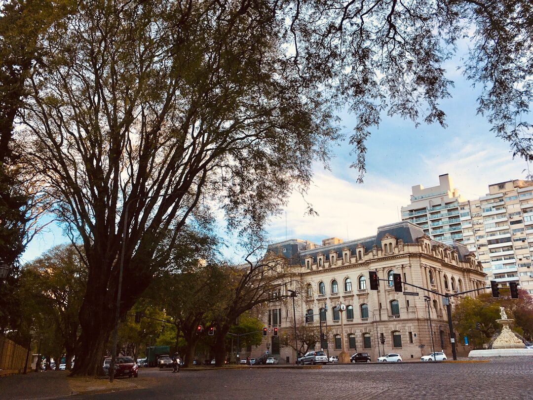 Car driving through wide avenue with European style buildings in Argentina