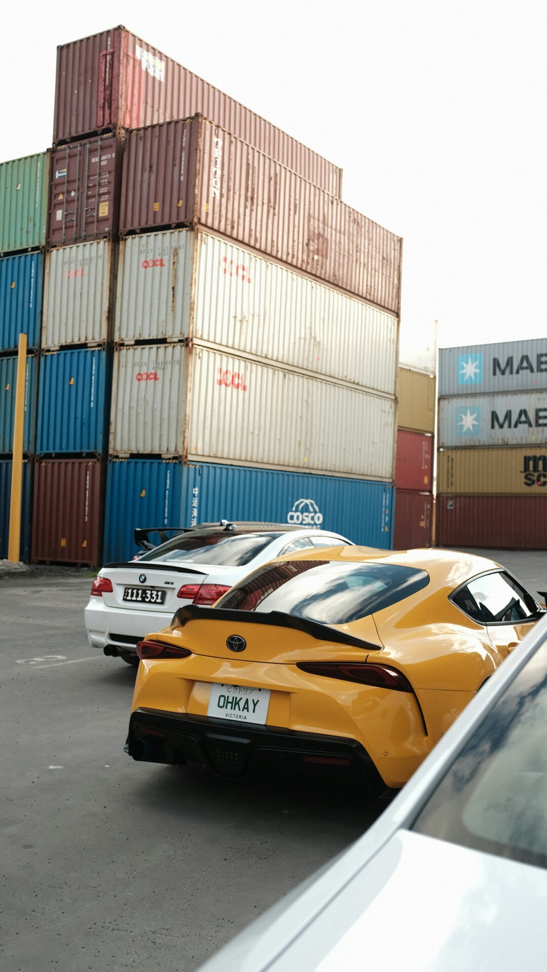 Cars being loaded into a shipping container at a port