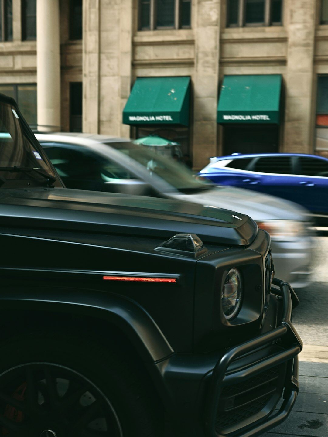 Black premium SUV parked in a modern urban setting