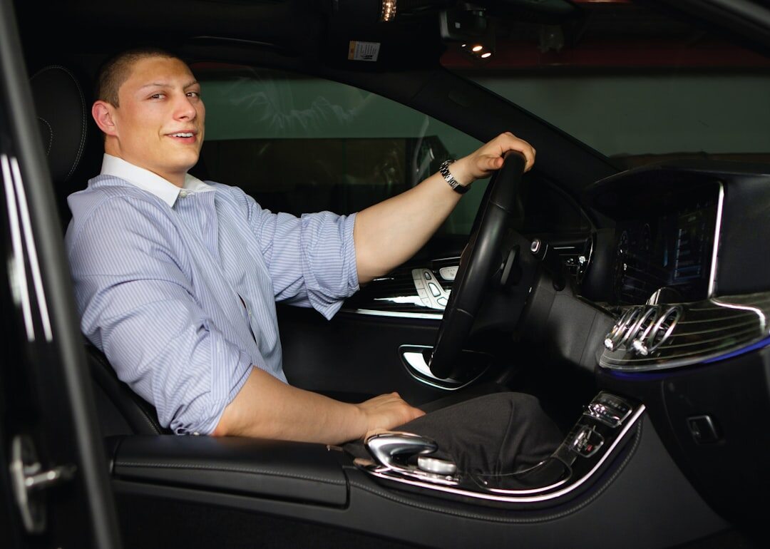 elegant man driving luxury car