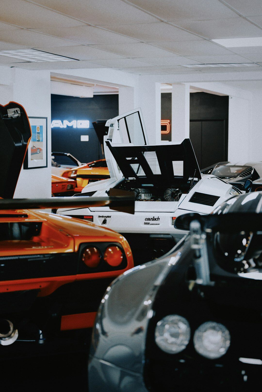 Diverse team of automotive specialists standing together in a modern showroom