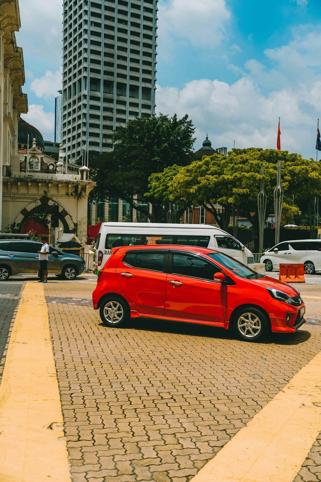 Compact red hatchback parked on a city street